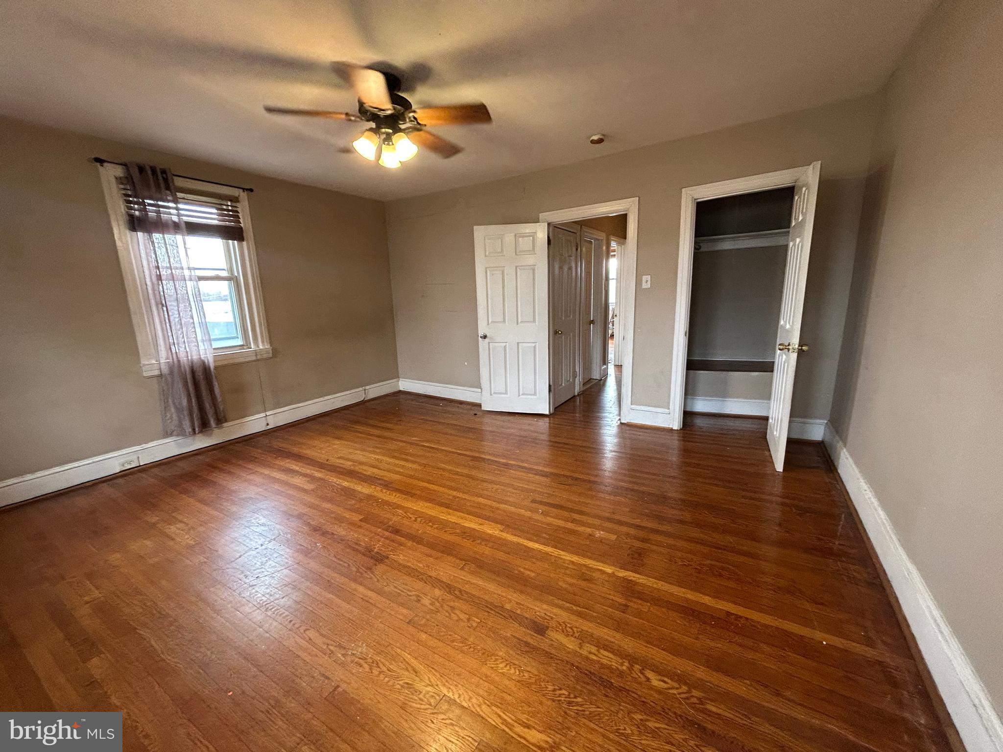 7502 Parkview Road Upper Darby, PA 19082 - Photo 22 of 63 wooden floor in an empty room with a window