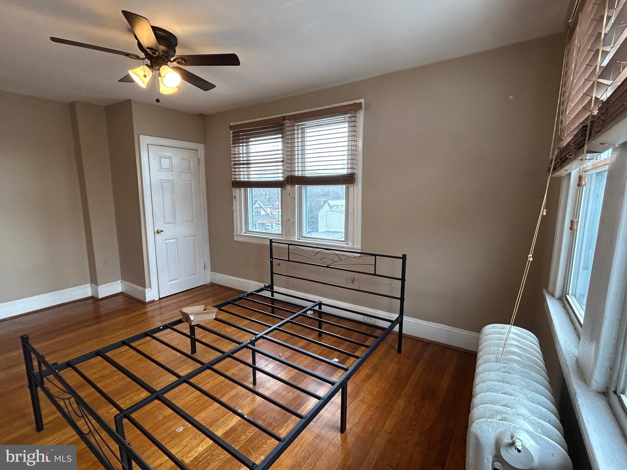 7502 Parkview Road Upper Darby, PA 19082 - Photo 27 of 63 a living room with a bed furniture a chandelier and a window