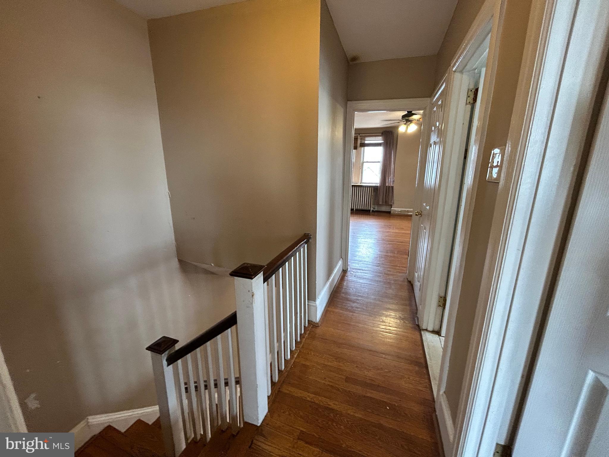 7502 Parkview Road Upper Darby, PA 19082 - Photo 30 of 63 a view of a hallway with wooden floor and staircase