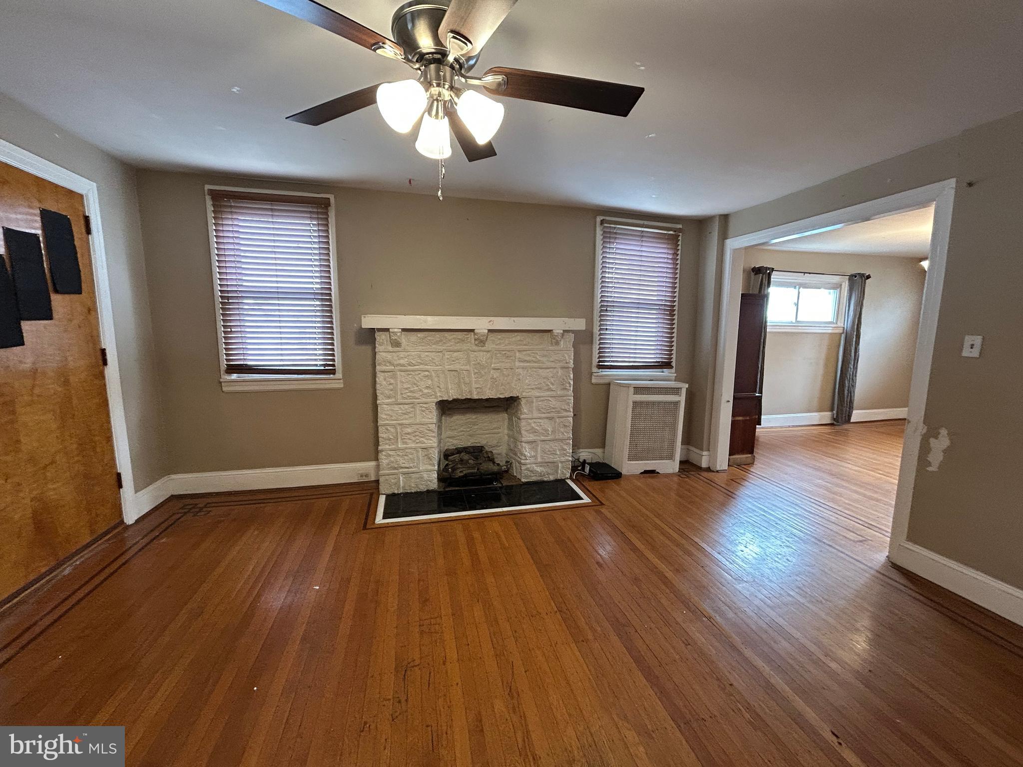 7502 Parkview Road Upper Darby, PA 19082 - Photo 5 of 63 a view of an empty room with wooden floor and a window