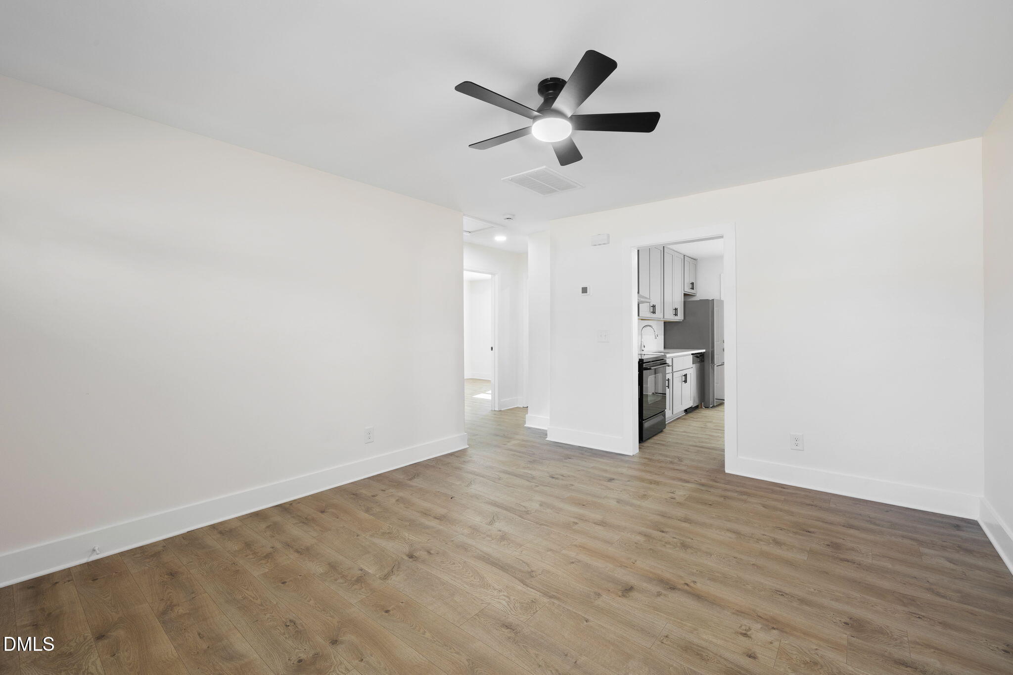 512 East Branch Street Spring Hope, NC 27882 - Photo 10 of 30 a view of a livingroom with a ceiling fan & wooden floor