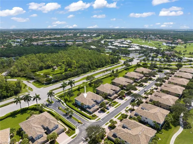 an aerial view of a city with lots of residential buildings and mountain view in back