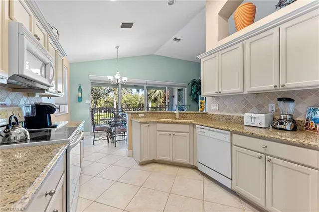a kitchen with stainless steel appliances granite countertop a sink and cabinets