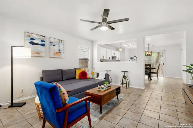 a living room with furniture and kitchen view