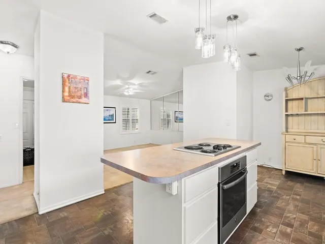 a kitchen with stainless steel appliances granite countertop a stove and a refrigerator