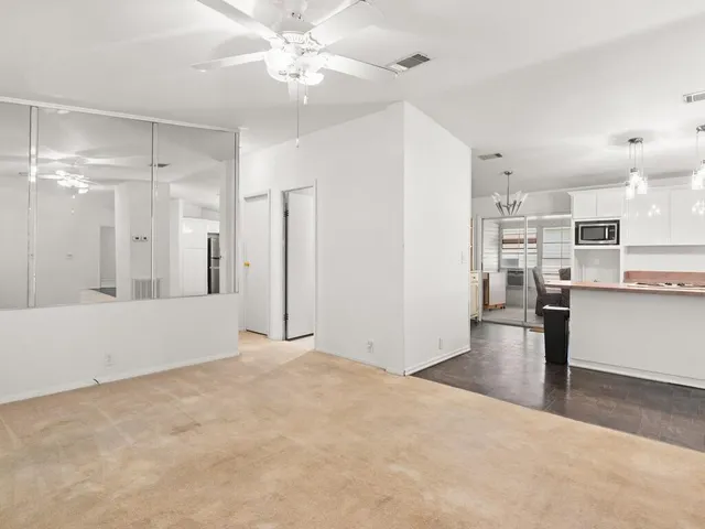 a view of a kitchen with wooden floor and a kitchen