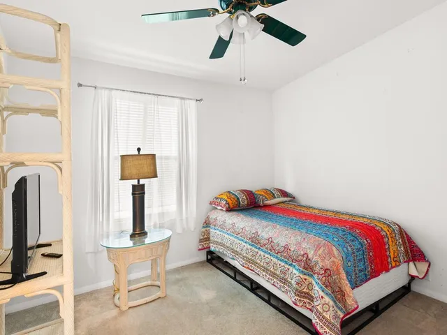 a bedroom with a bed and flat screen tv
