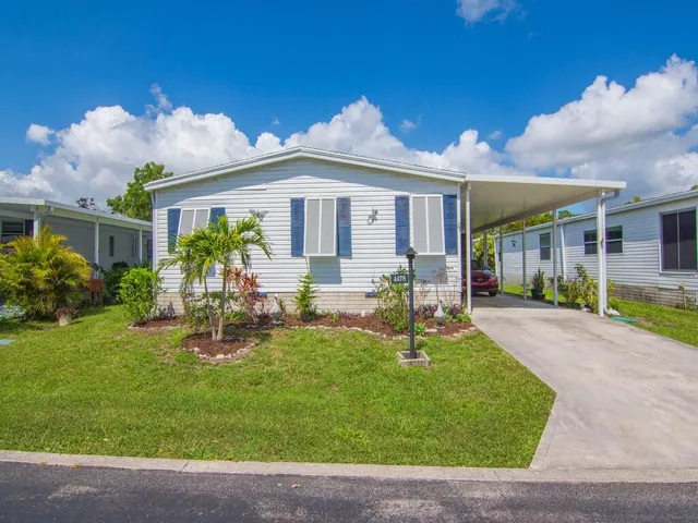 a front view of a house with garden and patio