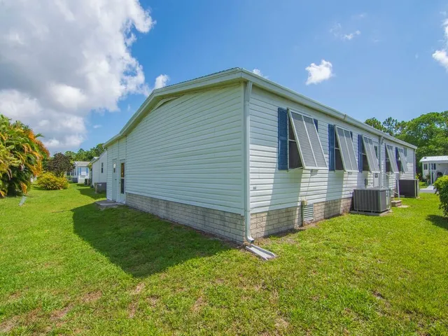a view of backyard with deck and garden