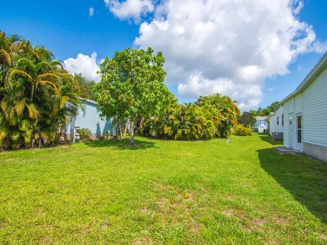 a view of a garden with an house and a yard