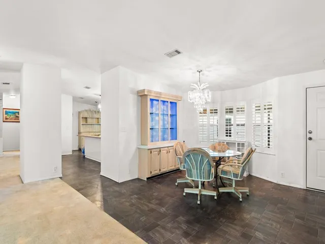 a view of a dining room with furniture and chandelier