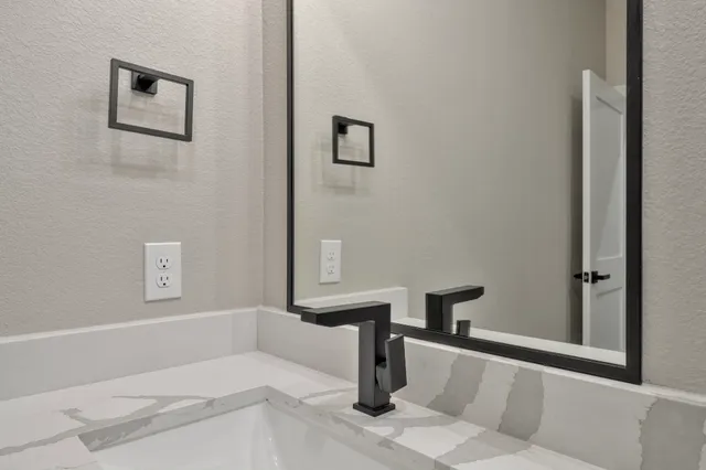 a view of a hallway with wooden floor and chandelier fan