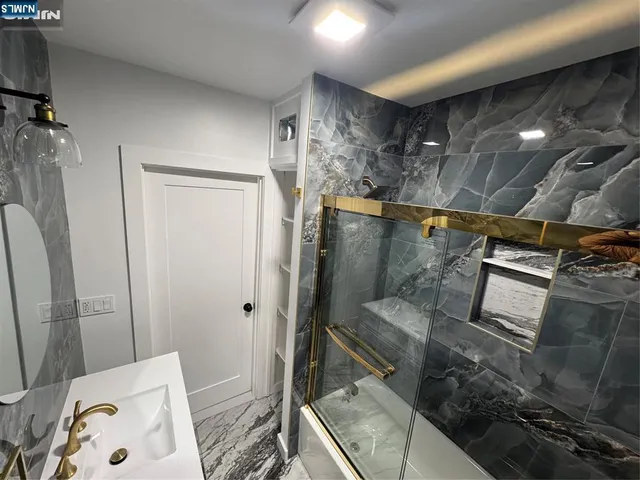 a bathroom with a tub and sink