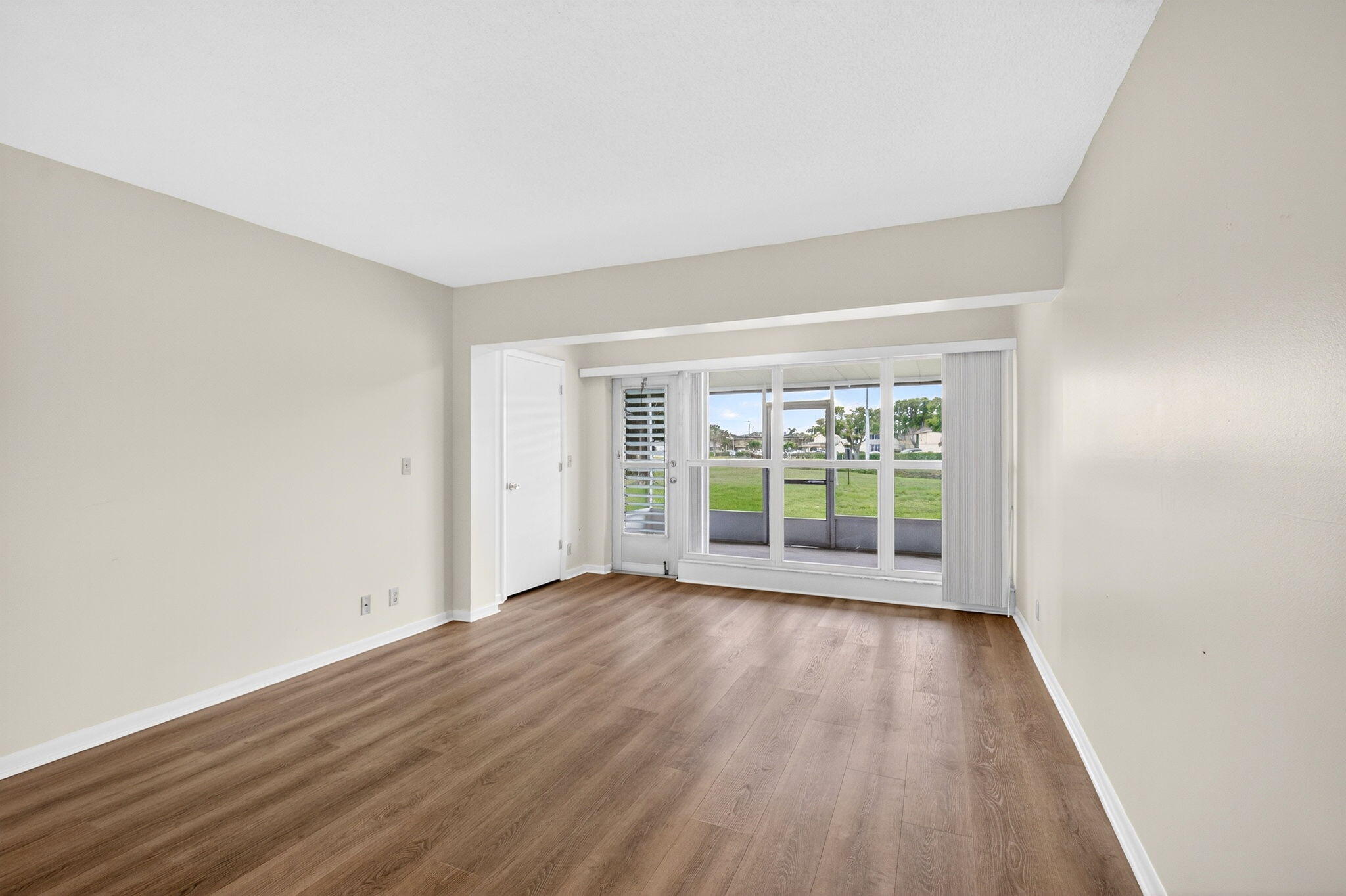 2840 Southwest 13th Street, Unit 103 Delray Beach, FL 33445 - Photo 11 of 72 wooden floor in an empty room with a window