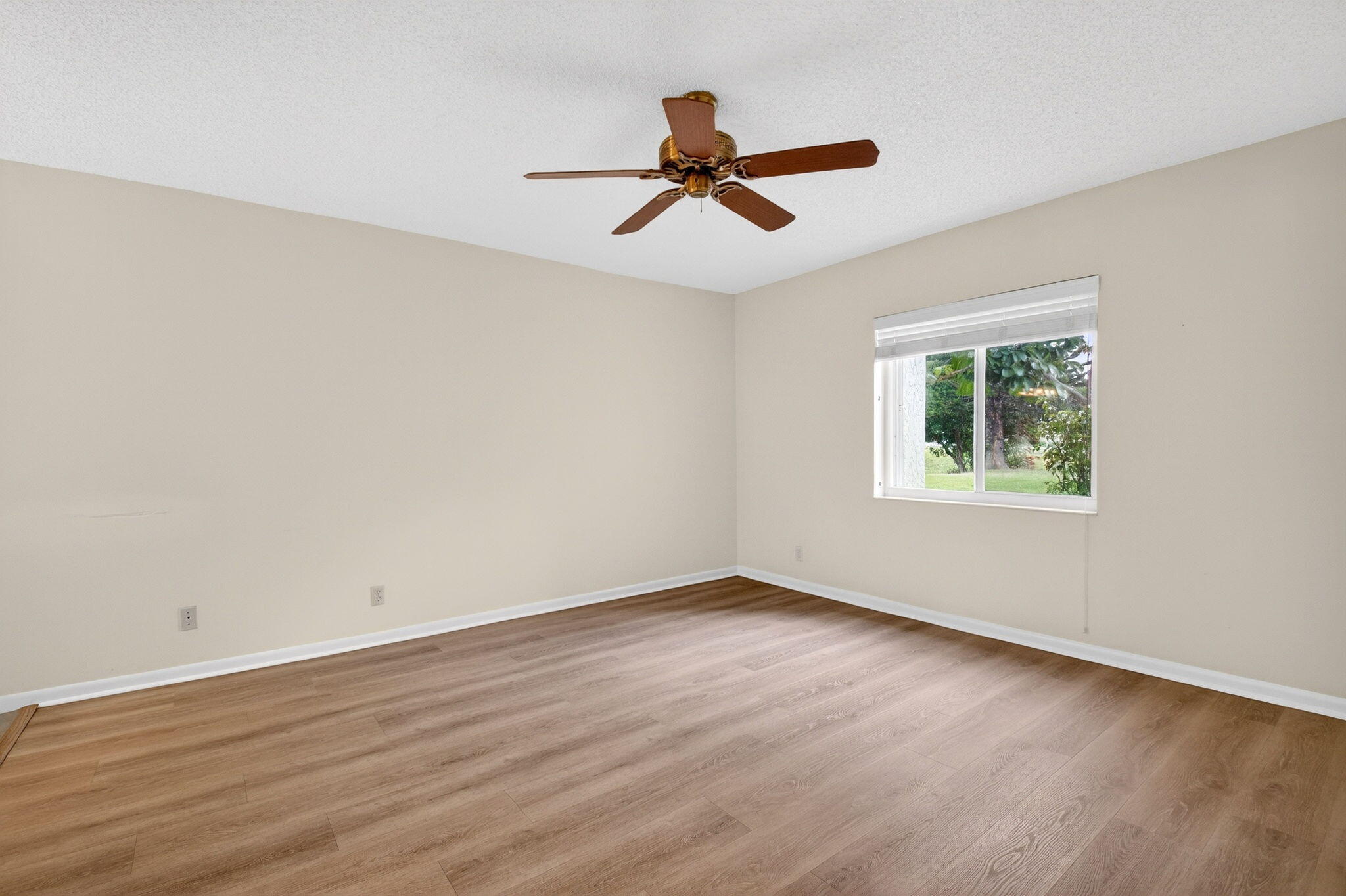 2840 Southwest 13th Street, Unit 103 Delray Beach, FL 33445 - Photo 22 of 72 a view of empty room with wooden floor and fan