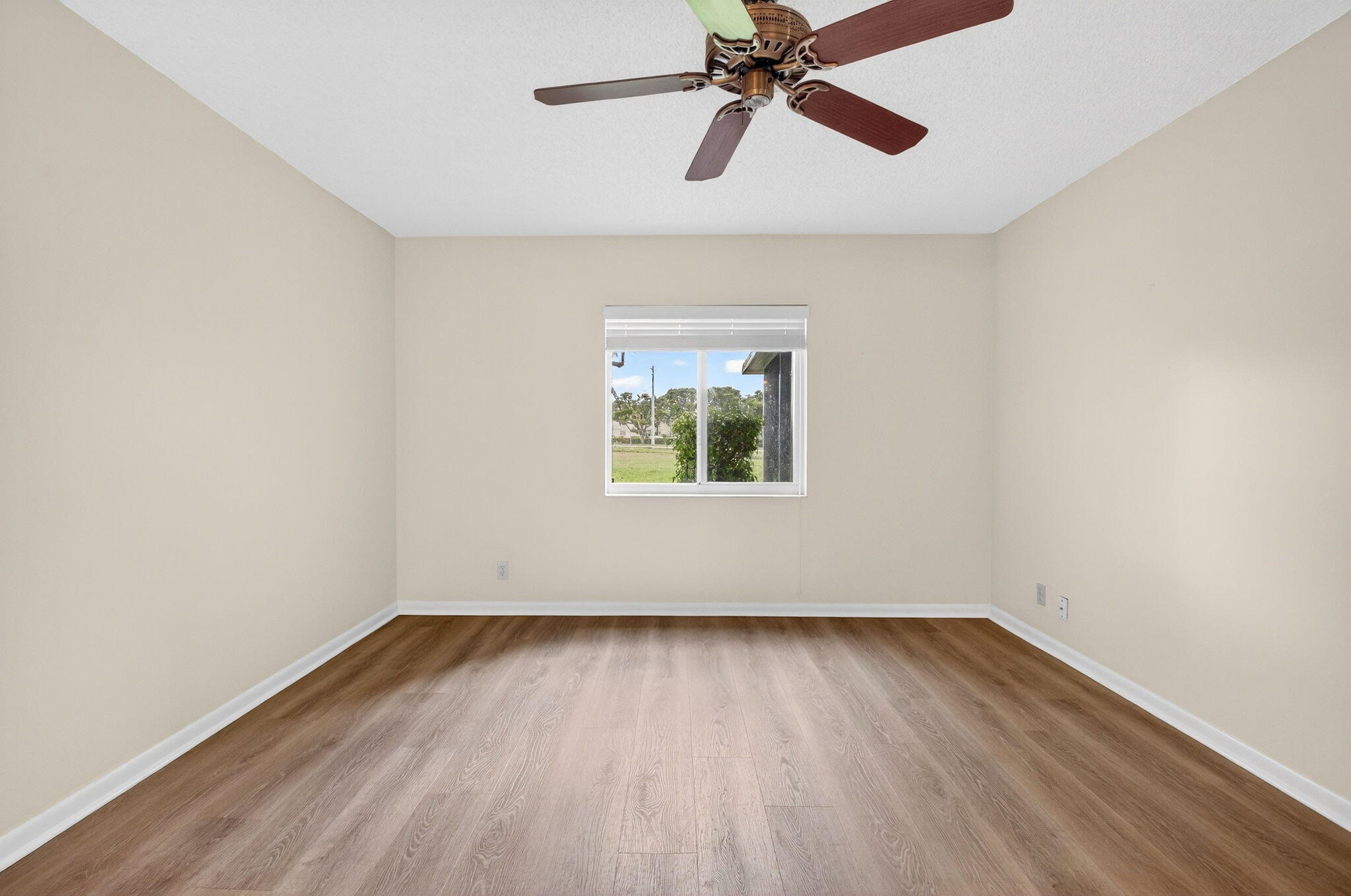 2840 Southwest 13th Street, Unit 103 Delray Beach, FL 33445 - Photo 23 of 72 an empty room with wooden floor closet and windows