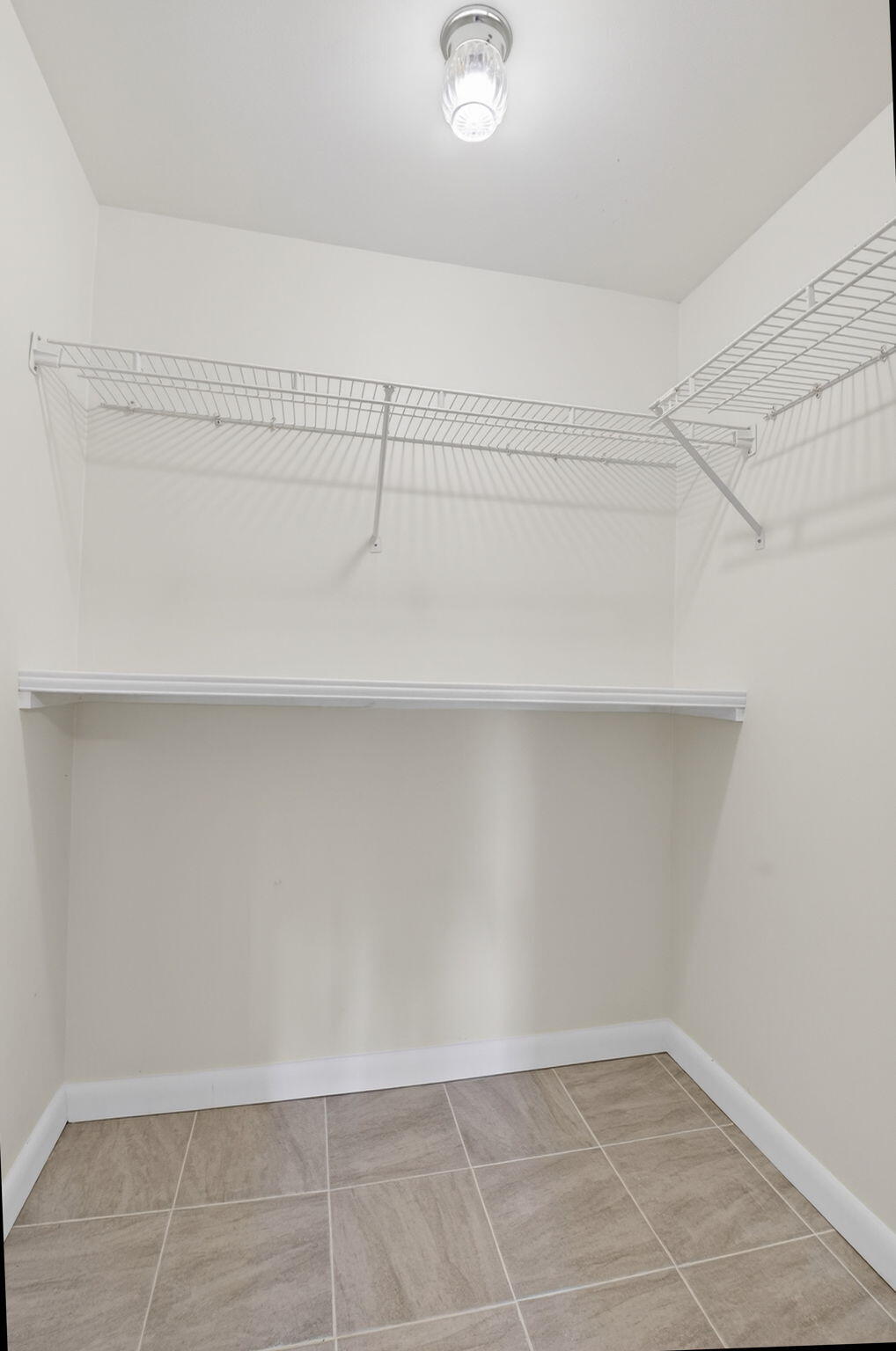 2840 Southwest 13th Street, Unit 103 Delray Beach, FL 33445 - Photo 28 of 72 a view of a room with racks on the wall
