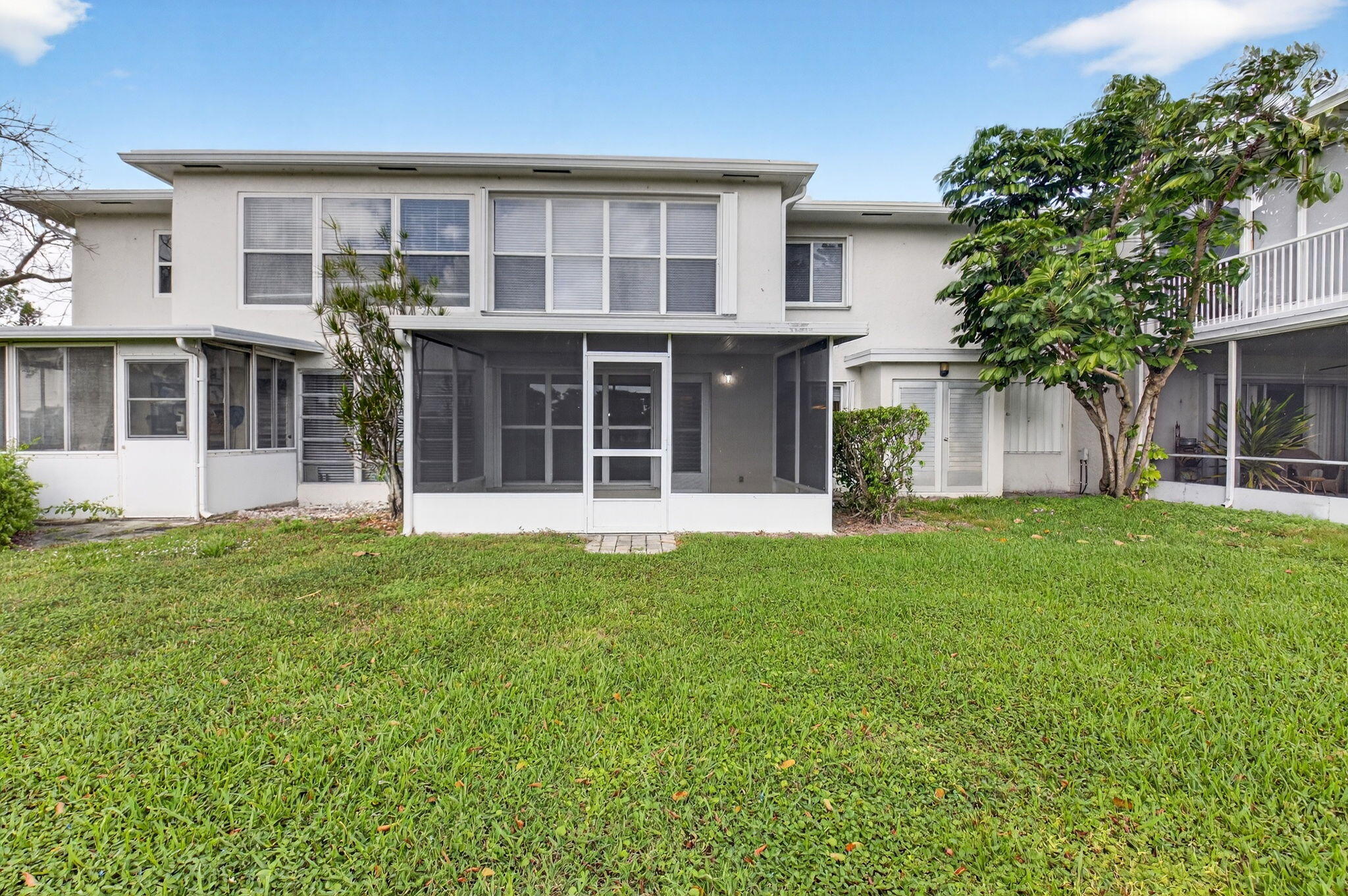 2840 Southwest 13th Street, Unit 103 Delray Beach, FL 33445 - Photo 42 of 72 front view of a house with a yard