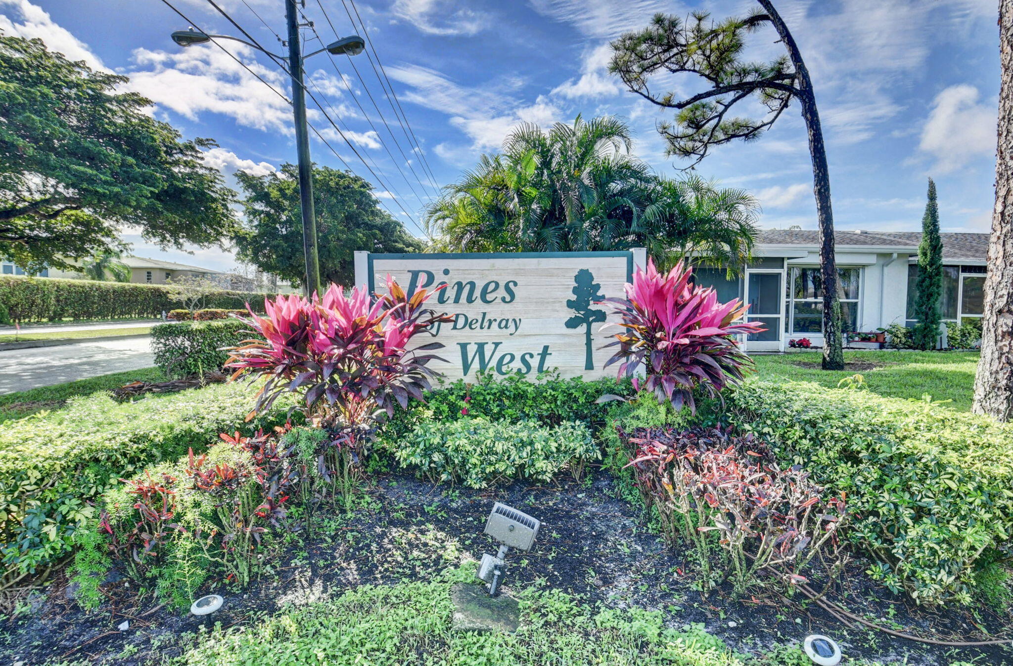 2840 Southwest 13th Street, Unit 103 Delray Beach, FL 33445 - Photo 59 of 72 a view of a sign in a yard