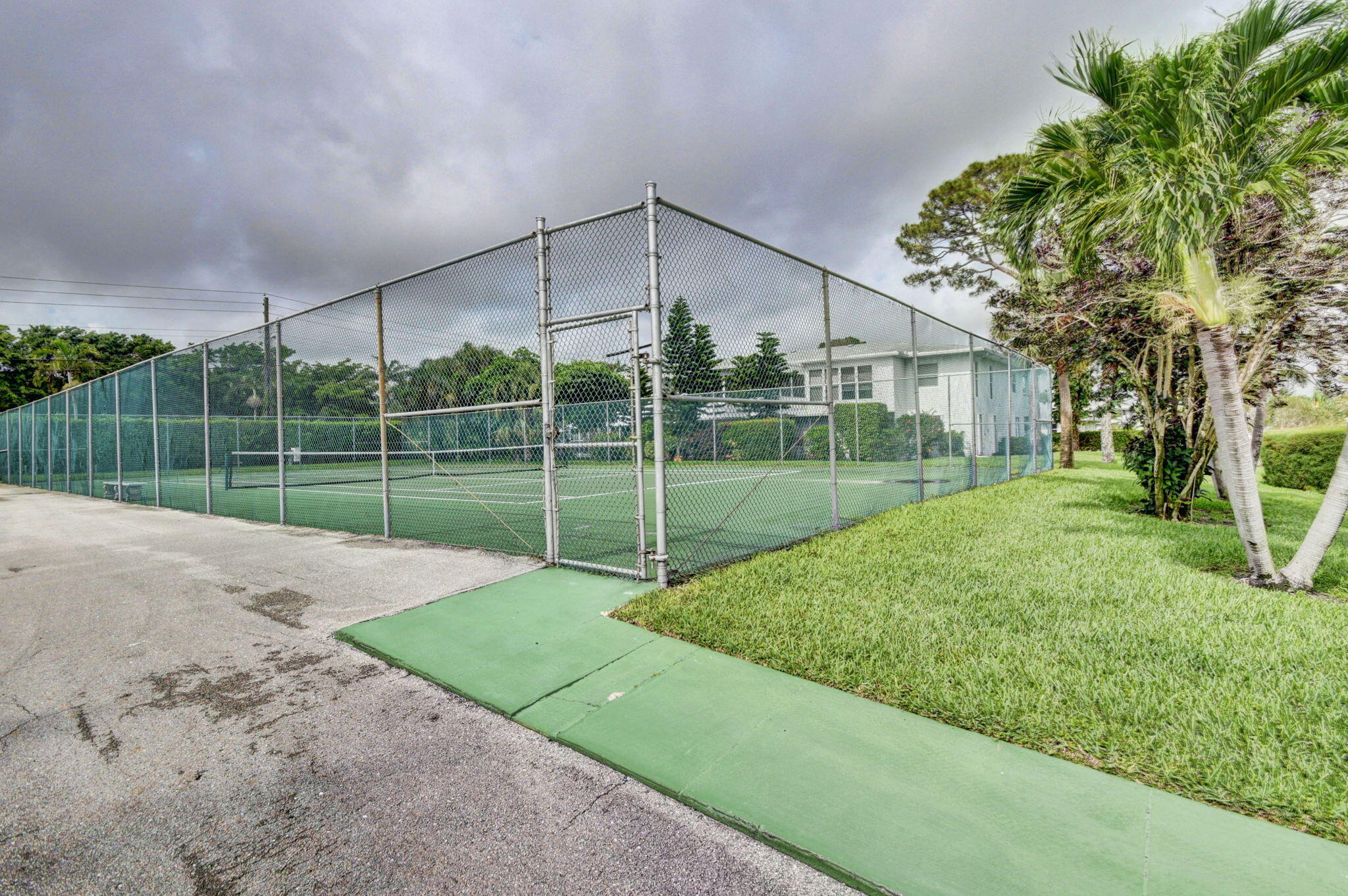 2840 Southwest 13th Street, Unit 103 Delray Beach, FL 33445 - Photo 71 of 72 a view of a backyard with a garden and entertaining space