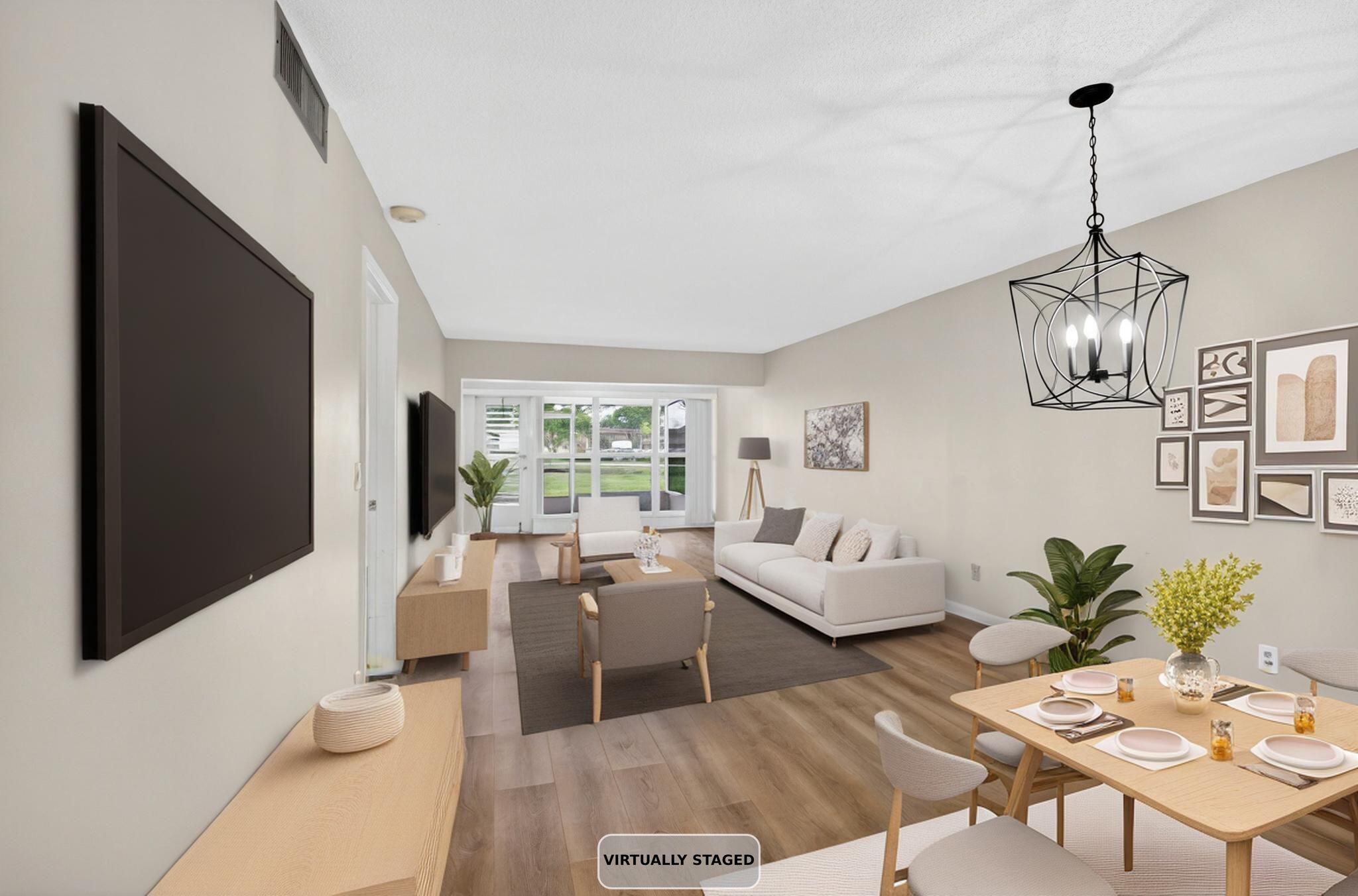 2840 Southwest 13th Street, Unit 103 Delray Beach, FL 33445 - Photo 8 of 72 a living room with furniture and floor to ceiling windows
