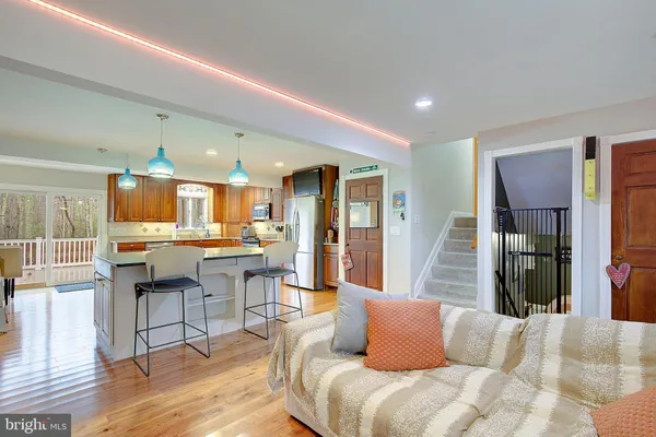 a kitchen with stainless steel appliances granite countertop a sink a stove and refrigerator