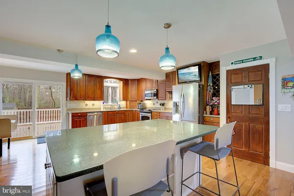 a kitchen with a sink cabinets and wooden floor