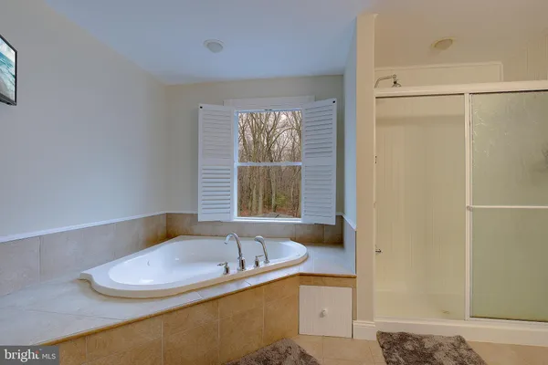 a bathroom with a sink vanity mirror and toilet