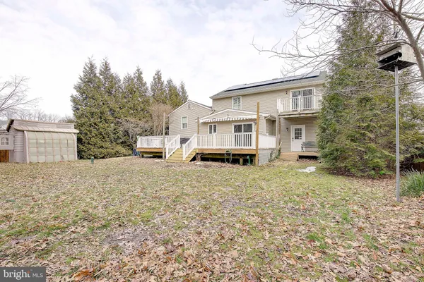 a white house that has a tree in front of it