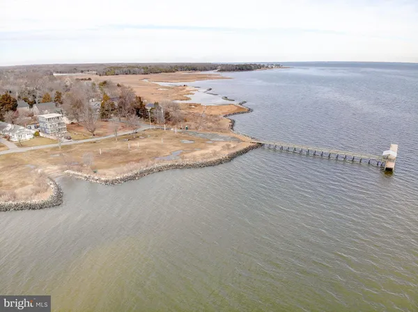 an aerial view of a house with a yard and lake view