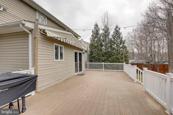 a view of a balcony with wooden floor and fence