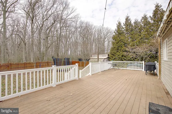 a view of a balcony with wooden floor and fence