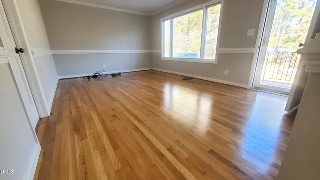 a view of a room with wooden floor and window