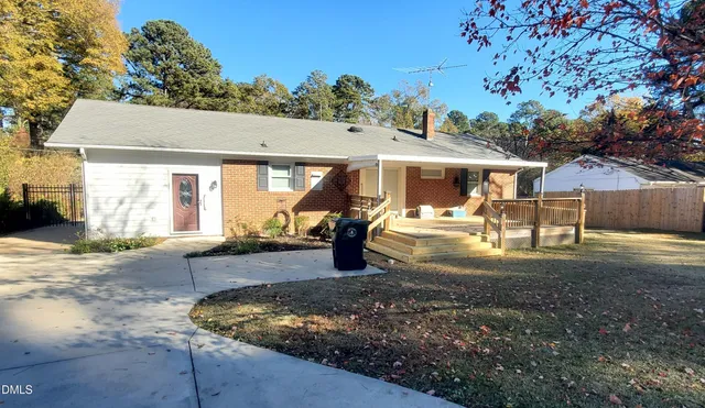 a view of a house with backyard porch and sitting area