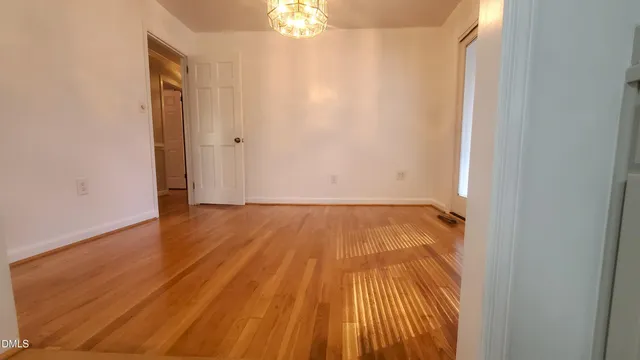 a view of a room with wooden floor