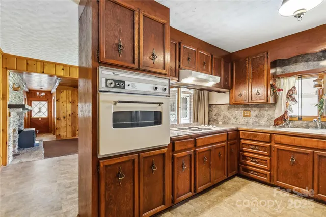 a kitchen with stainless steel appliances granite countertop a stove sink and cabinets