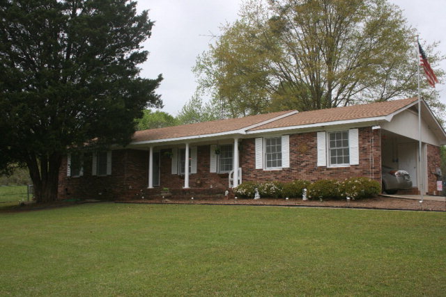 2735 Bonner Gilbert Road Lizella, GA 31052 - Photo 1 of 25 a front view of a house with a garden and porch