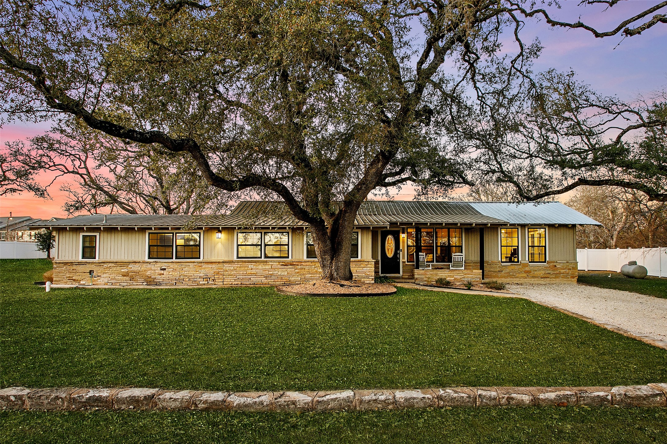 200 Creek Road Dripping Springs, TX 78620 - Photo 1 of 1 Digitally enhanced grass on a single story home featuring stone siding and a porch