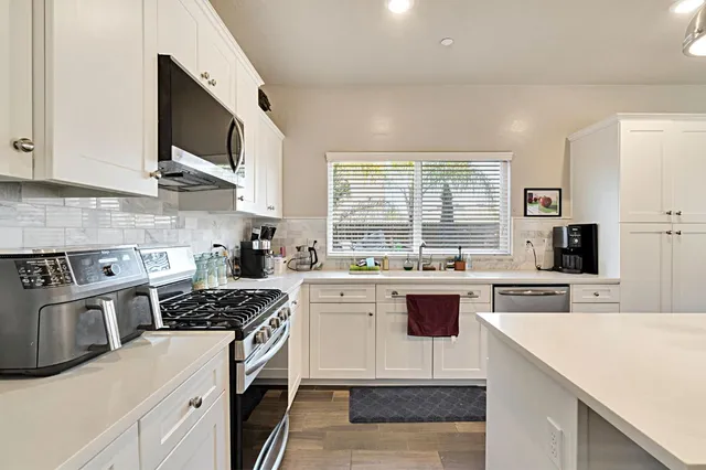 a kitchen with a stove a sink and a microwave