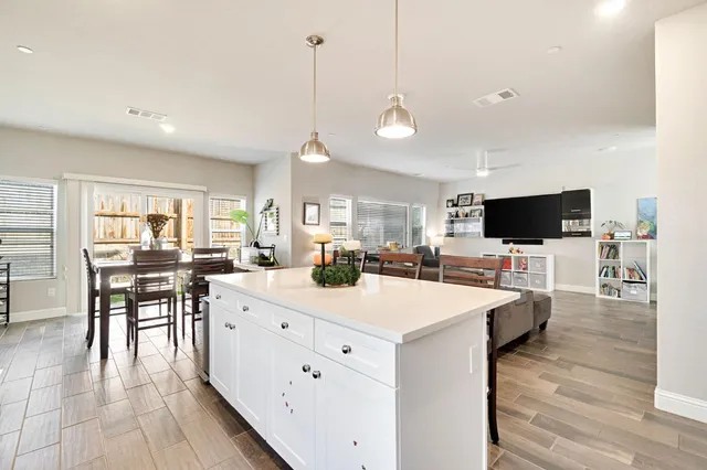 a large kitchen with a table and chairs