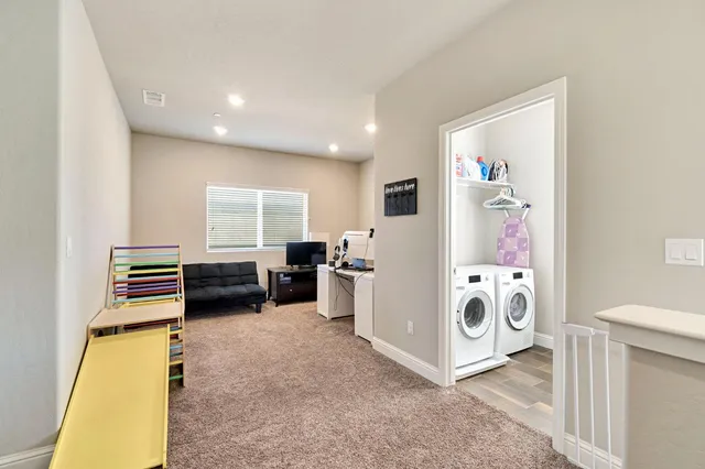a view of kitchen and utility room with washer and dryer