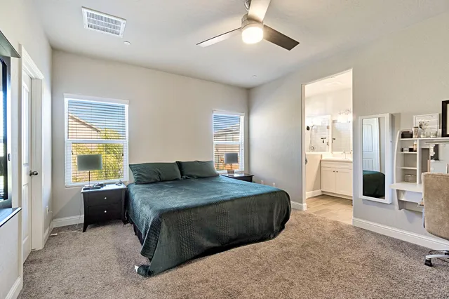 a bedroom with a large bed and a chandelier