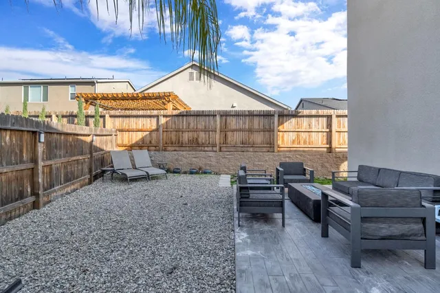 a backyard of a house with outdoor seating