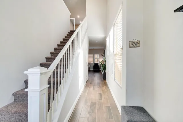 a view of a hallway with wooden floor and entryway