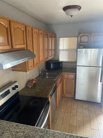 a kitchen with a sink stove and refrigerator