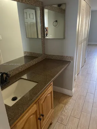 a kitchen with a sink a refrigerator and window
