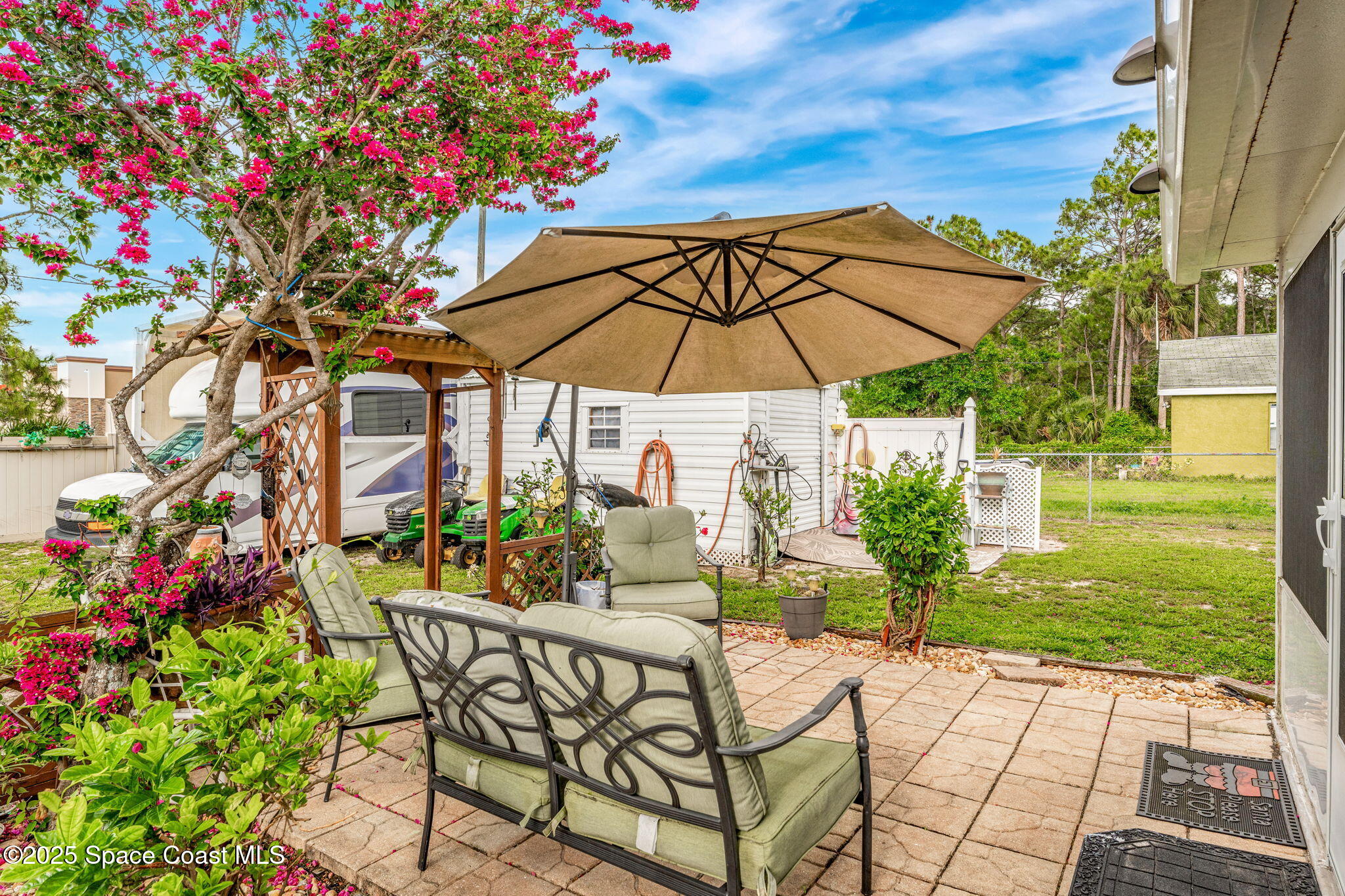 198 White Road Southwest Palm Bay, FL 32908 - Photo 32 of 47 a patio with a patio table and chairs