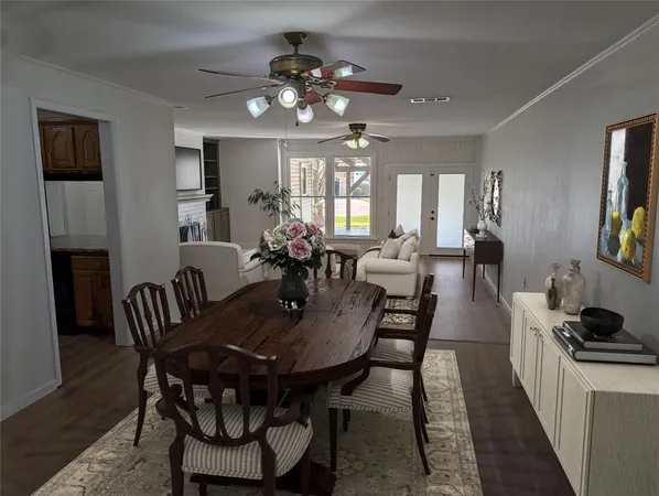 a view of a a dining room with furniture window and wooden floor