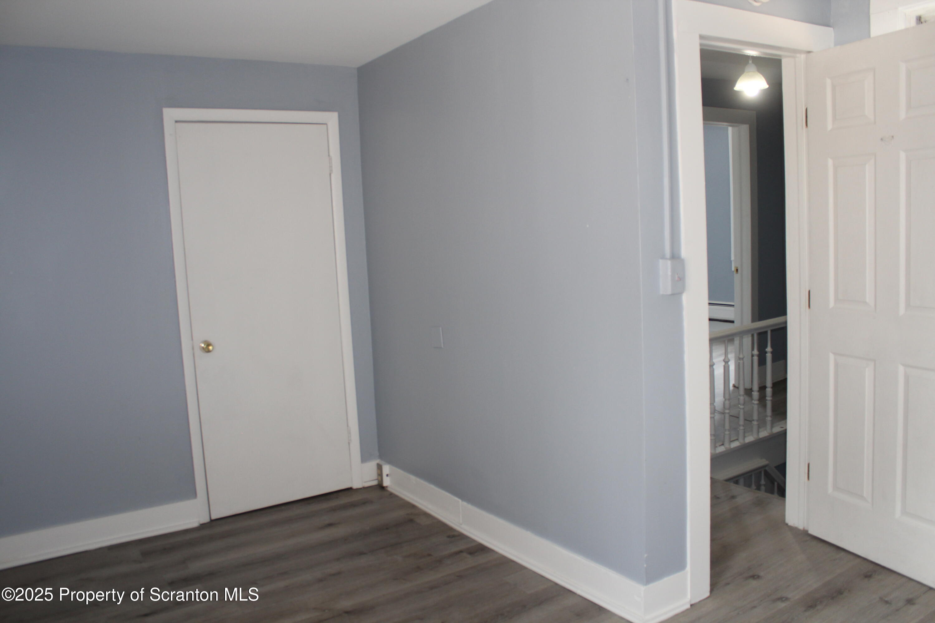 1507 Luzerne Street Scranton, PA 18504 - Photo 16 of 26 a view of an empty room with wooden floor