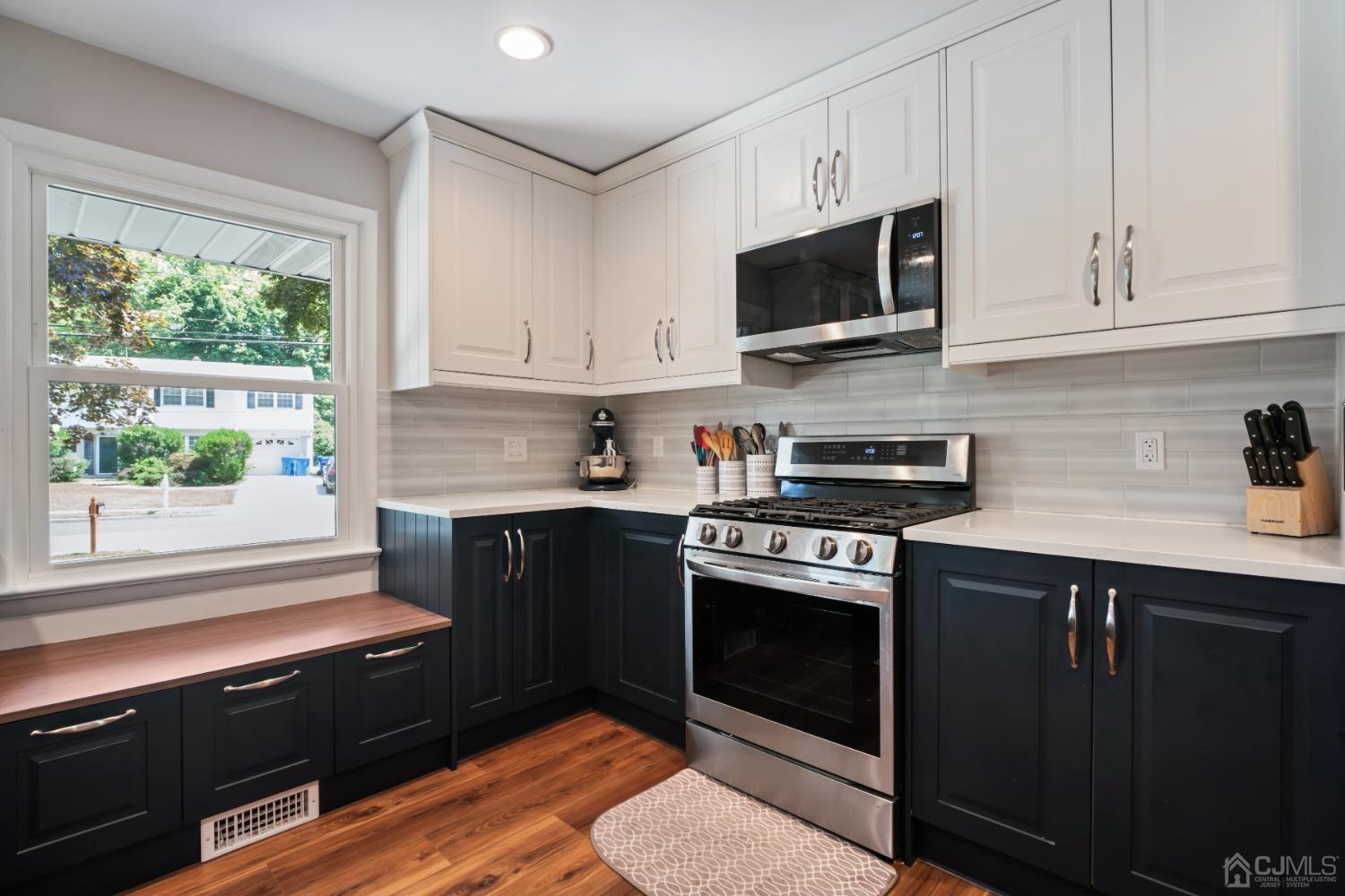 296 Colfax Road North Brunswick, NJ 08902 - Photo 13 of 37 a kitchen with stainless steel appliances granite countertop a stove a sink and a microwave